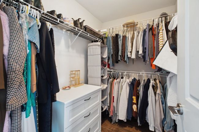Walk in closet featuring dark wood-style flooring | Image 18
