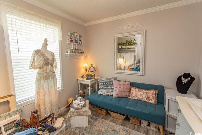 Den/Bedroom room with baseboards, wood finished floors, and crown molding | Image 13