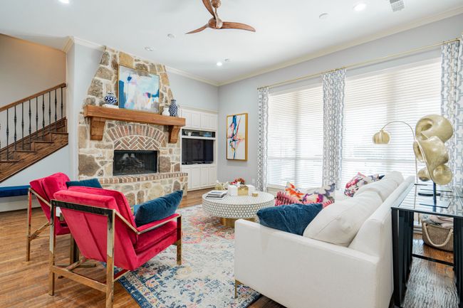 Living room featuring a ceiling fan, ornamental molding, and wood finished floors | Image 17