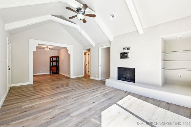 This home has hugh Vaulted ceiling with Real Wood Beams | Image 11
