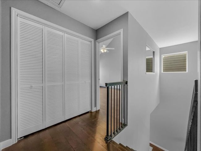 Hallway with dark wood-type flooring - In the closet there are a washer and a dryer | Image 25