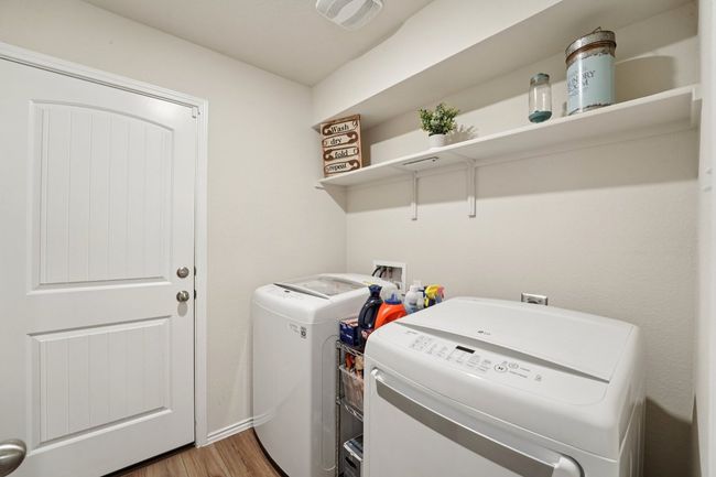 Laundry room featuring separate washer and dryer and light wood-style flooring | Image 16