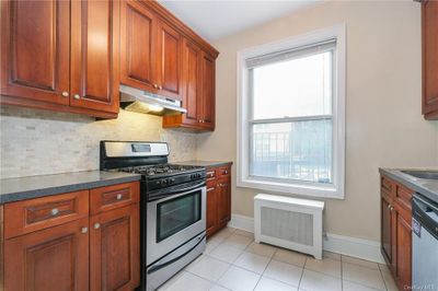 Large kitchen w/ stainless steel appliances & wood cabinets | Image 1