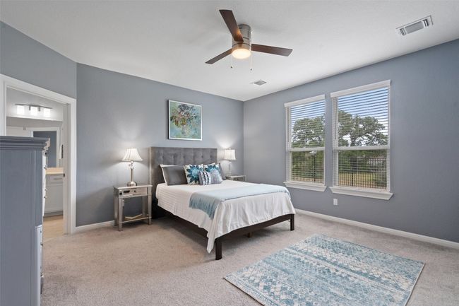 The primary retreat overlooks the backyard, and features an ensuite bathroom. | Image 19