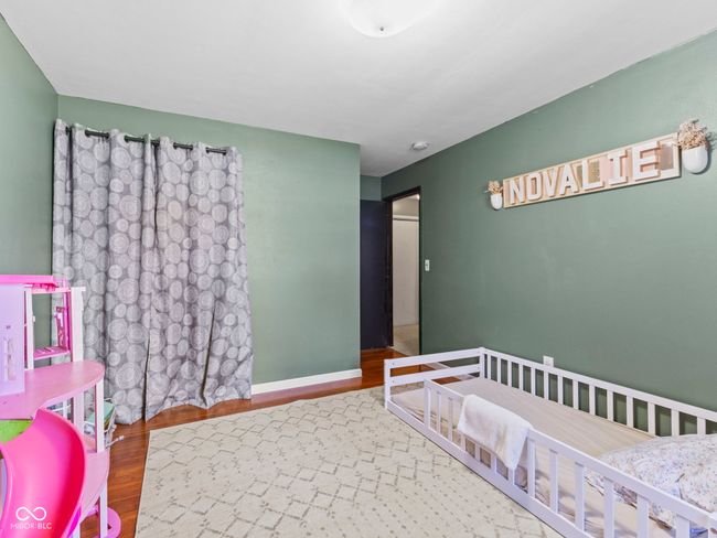 bedroom featuring baseboards and wood finished floors | Image 23