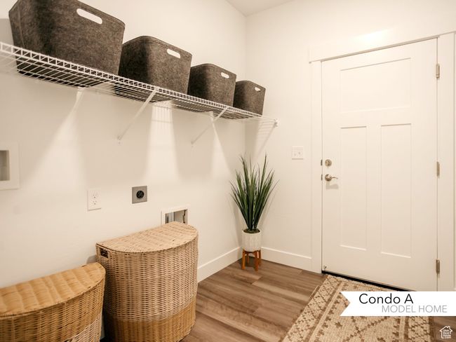 Clothes washing area featuring hookup for an electric dryer, laundry area, hookup for a washing machine, and wood finished floors | Image 9