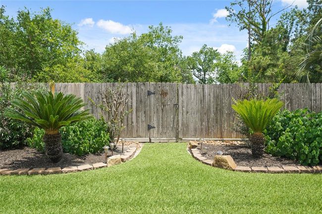 Pictured is a gate that leads to a wooded area behind the home. That's right, no back neighbors! | Image 31