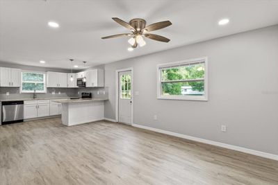 Living/Dining Room Combo...Freshly Painted Interior w/ NEW Ceiling Fans, Blinds & Luxury Vinyl Planking Thoroughout | Image 2