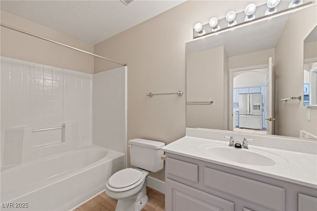 Bathroom featuring bathing tub / shower combination and vanity | Image 16
