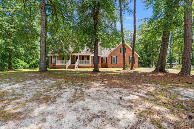 View of front of property featuring covered porch and brick siding | Image 34