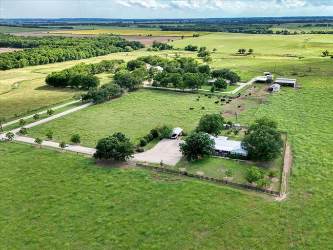 Aerial view of sparsely populated area featuring extensive farmland | Image 4