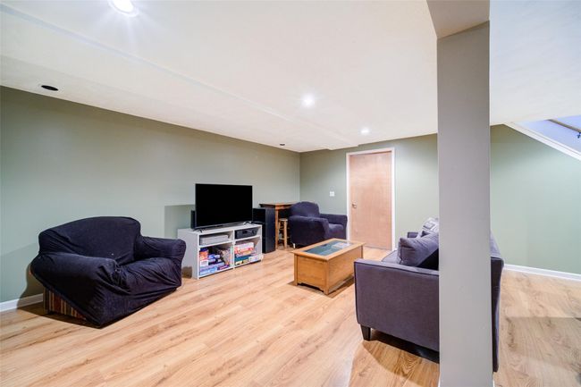 Living room with recessed lighting, wood finished floors, and baseboards | Image 36