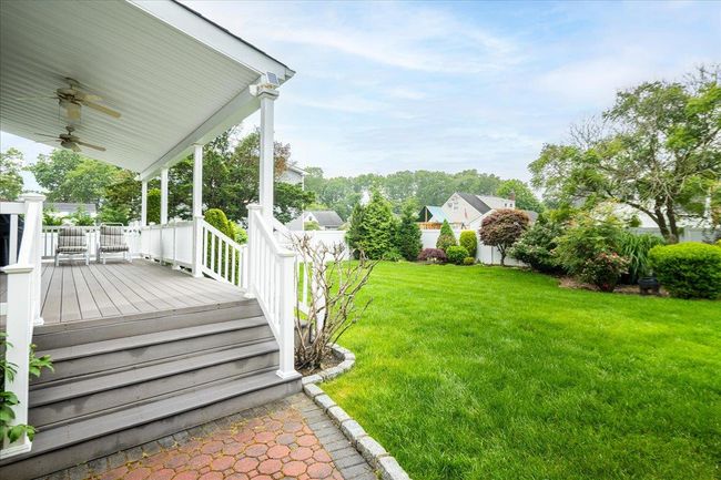 View of yard with ceiling fan and covered porch | Image 32