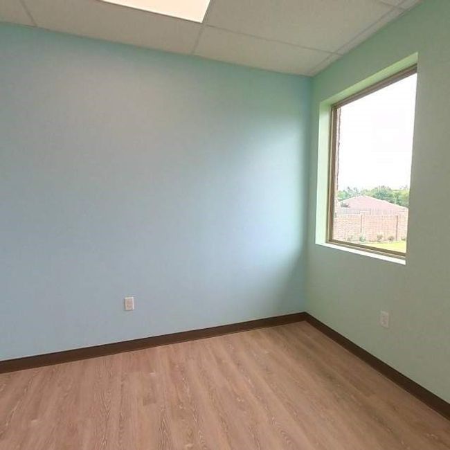 Unfurnished room featuring a drop ceiling, light wood-style floors, and baseboards | Image 14