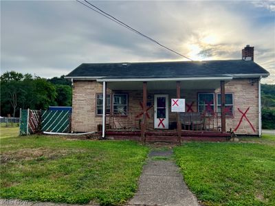 View of front of home featuring a porch and a front yard | Image 1