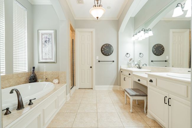 Full bath with tile patterned flooring, a garden tub, and crown molding | Image 19
