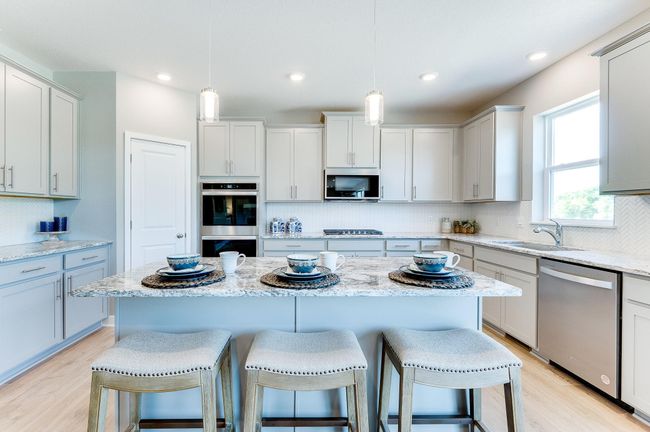 A kitchen that is equal parts open and inviting throughout, the space will be the focal point of gatherings for years to come! Photo of model home, color and options will vary. | Image 14