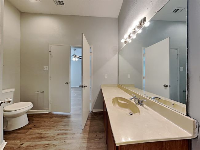 Bathroom with wood finished floors and vanity | Image 10