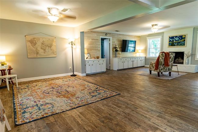 View from left of french doors with living area to the left and den to the right. | Image 13