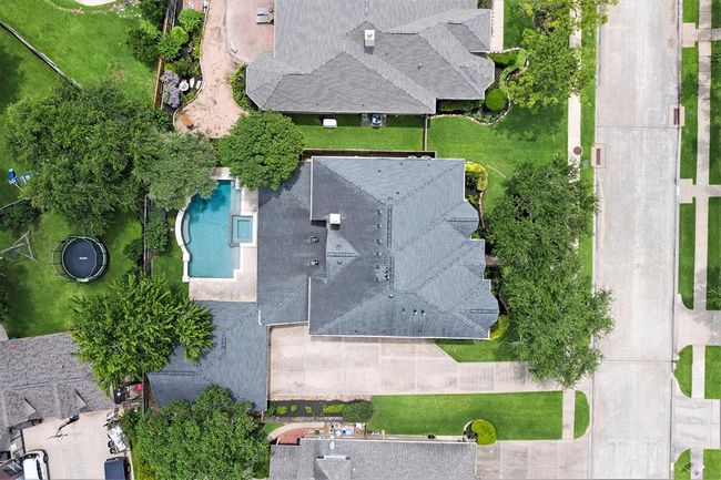 This aerial view shows you the expansive driveway, tropical pool and matures trees! But it doesn't show you the extended garage add-on with it being 23'8" x 10'x6" at the back with a workshop area and recent garage doors! And...a whole HOME GENERATOR too! | Image 42