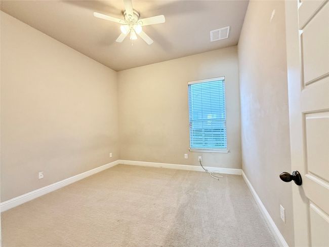 Unfurnished room with light colored carpet and a ceiling fan | Image 35