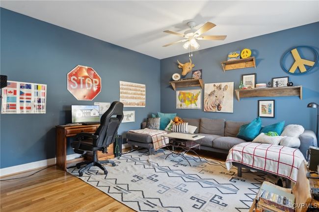 Home office featuring ceiling fan, baseboards, and wood finished floors | Image 28