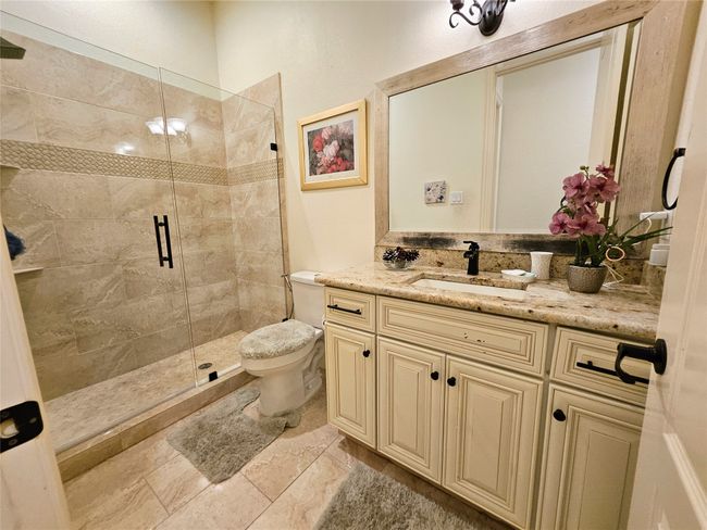 Full bathroom featuring a shower stall, vanity, and toilet | Image 28