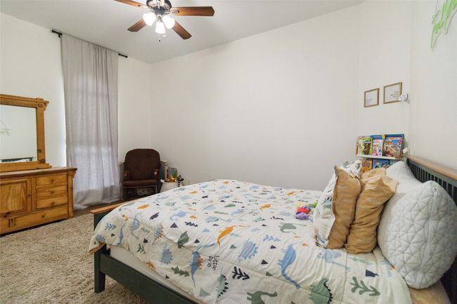 Bedroom featuring ceiling fan and carpet flooring | Image 16