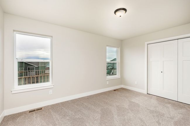Unfurnished bedroom featuring a closet, visible vents, carpet flooring, and baseboards | Image 10