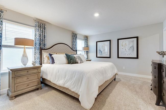The primary bedroom is the perfect setting to start and finish each day! Furnished with a King size bed and furniture with plenty of space leftover. Photo of model, colors and options will vary. | Image 12