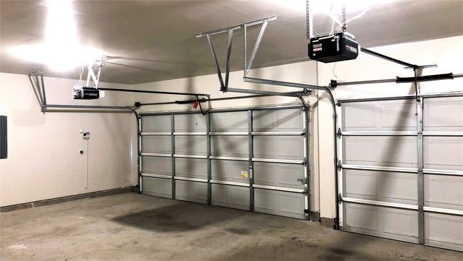 Garage featuring a garage door opener and electric panel | Image 32