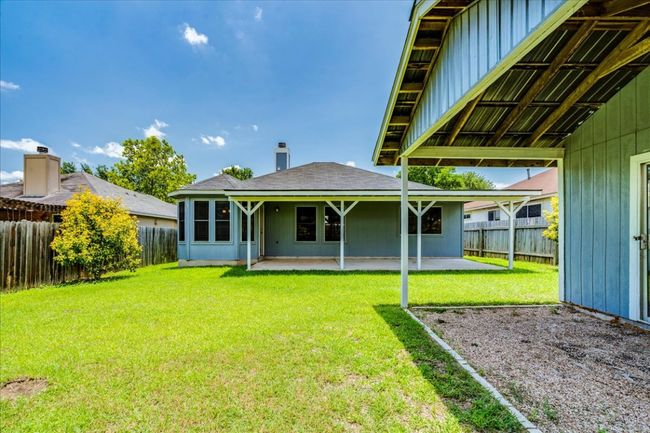 Backyard features storage shed with covered patio | Image 33