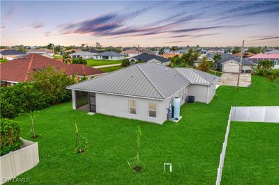 Back yard with partial fencing from neighbors. Plenty of room for a pool and the location provides easy access to Cape Coral, North Ft Myers and Punta Gorda! | Image 3