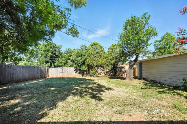 View of fenced backyard | Image 24