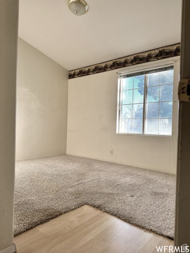 Unfurnished room featuring lofted ceiling and light wood finished floors | Image 32