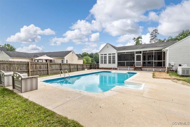View of swimming pool with a sunroom, a patio area, a fenced backyard, and cooling unit | Image 49