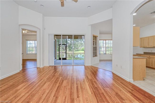Unfurnished living room with a wealth of natural light, light hardwood / wood-style floors, and ceiling fan | Image 21