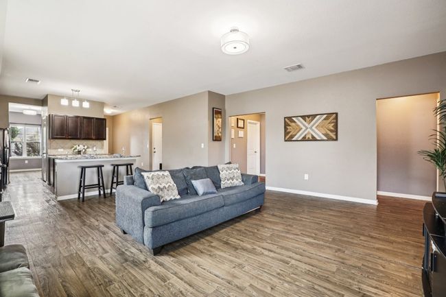 Living area featuring wood finished floors and baseboards | Image 12