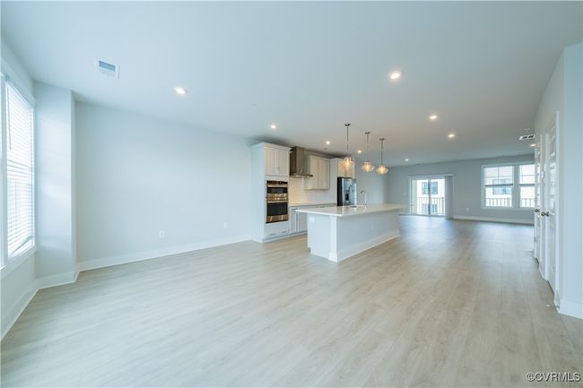 Unfurnished living room with recessed lighting, a sink, baseboards, and light wood-type flooring | Image 21