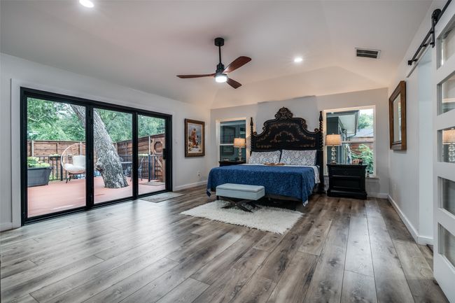Bedroom featuring access to exterior, wood finished floors, lofted ceiling, recessed lighting, and a ceiling fan | Image 16