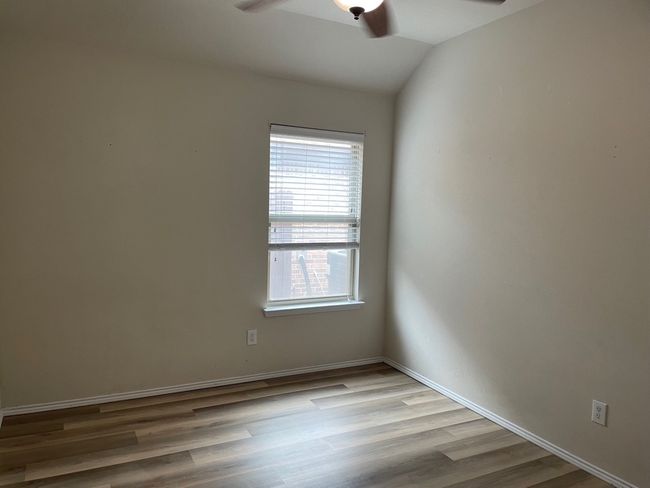 Spare room featuring ceiling fan, wood finished floors, and lofted ceiling | Image 4