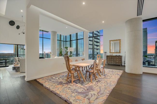 Positioned to take full advantage of panoramic skyline views, the dining area offers a stunning backdrop for any meal. | Image 9
