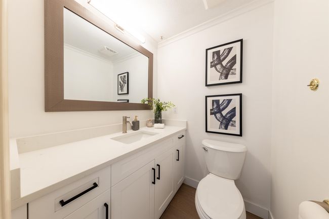 Bathroom featuring crown molding, toilet, vanity, baseboards, and visible vents | Image 21