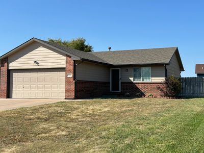 Single story home featuring a front lawn and a garage | Image 1