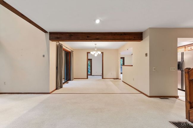 Beautiful wood beam frames the dining room! | Image 9