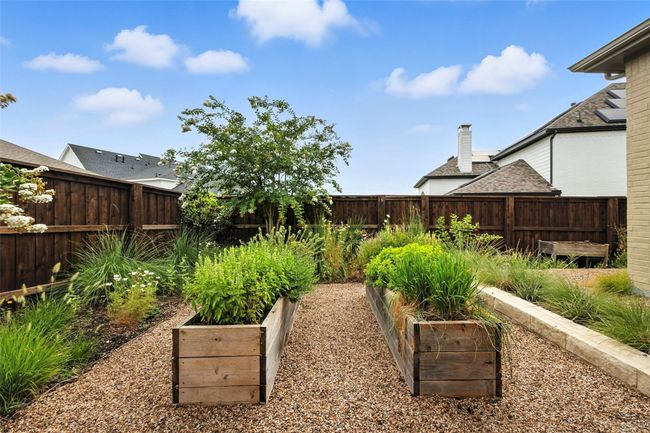 Fenced backyard with a garden | Image 32