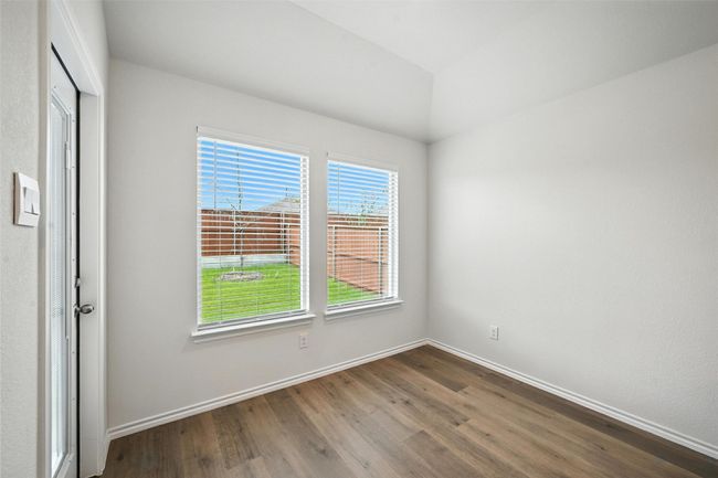Spare room with dark wood finished floors and baseboards | Image 13
