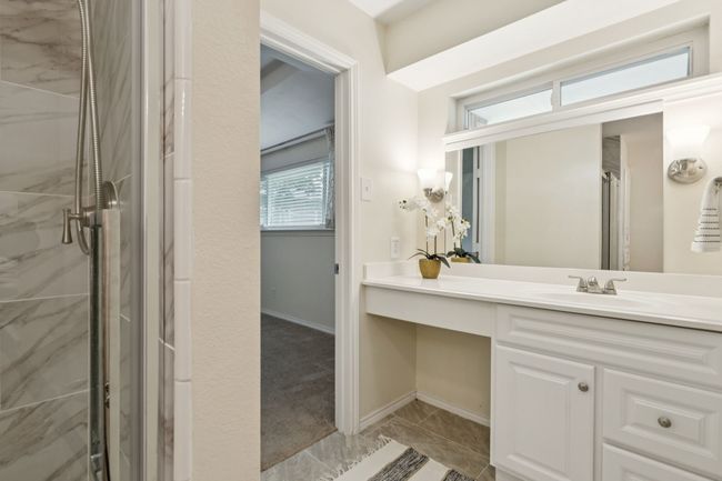 Primary Ensuite Bathroom with double vanities, dual sinks, and frameless walk-in shower | Image 16