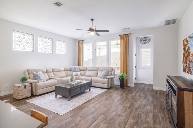 Living room with ceiling fan, dark wood finished floors | Image 12