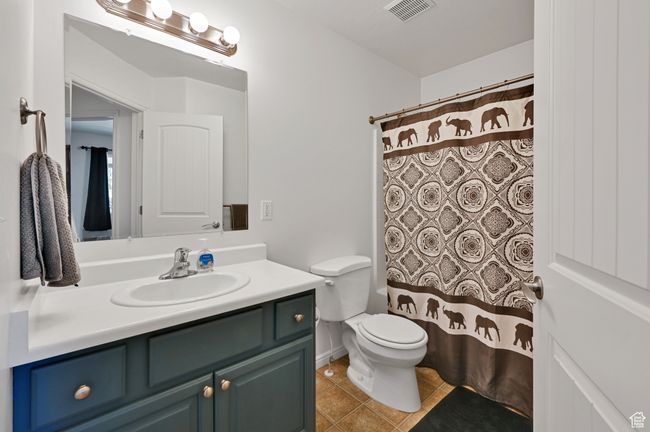 Bathroom with tile patterned flooring, vanity, and toilet | Image 22
